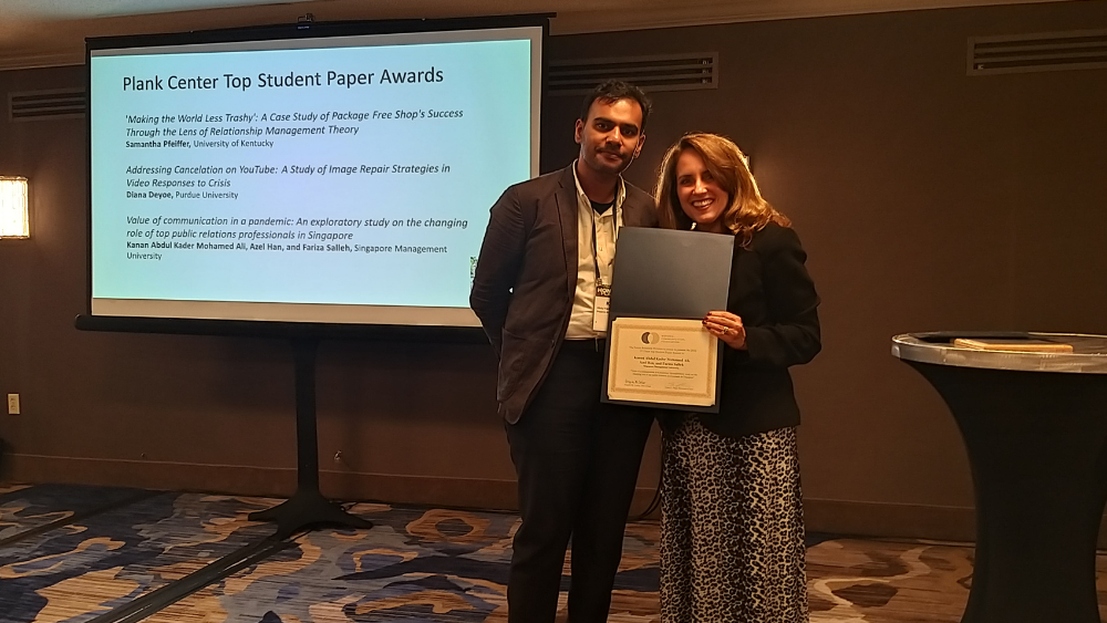 : Kader receiving the student paper award at the US National Communication Association’s (NCA’s) 108th Annual Convention: Honoring PLACE: People, Liberation, Advocacy, Community, and Environment