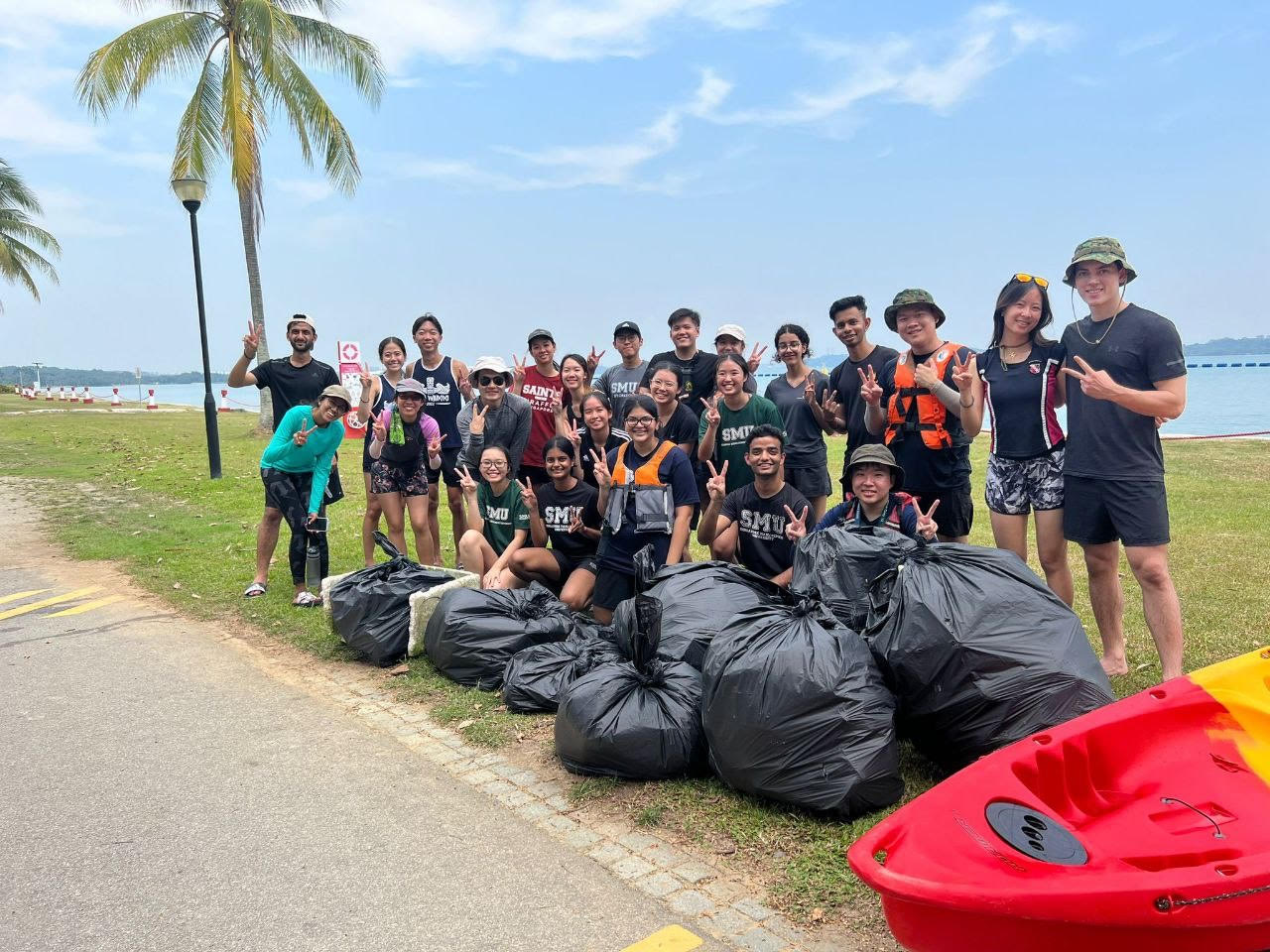 Derick (2nd row, 3rd from left in hat and sunglasses) took part in a coastal clean-up exercise with SMU Verts